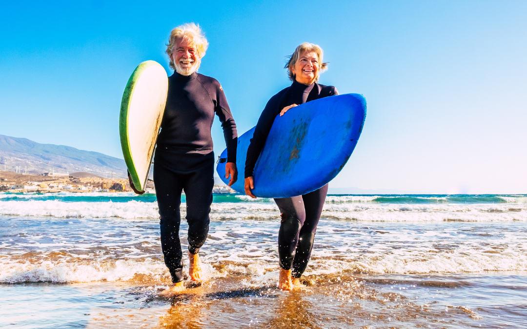 Healthy Aging - Happy older couple enjoying a day of surfing